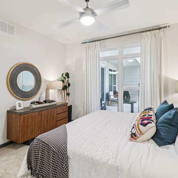 a bedroom with a large bed and a mirror on the wall.