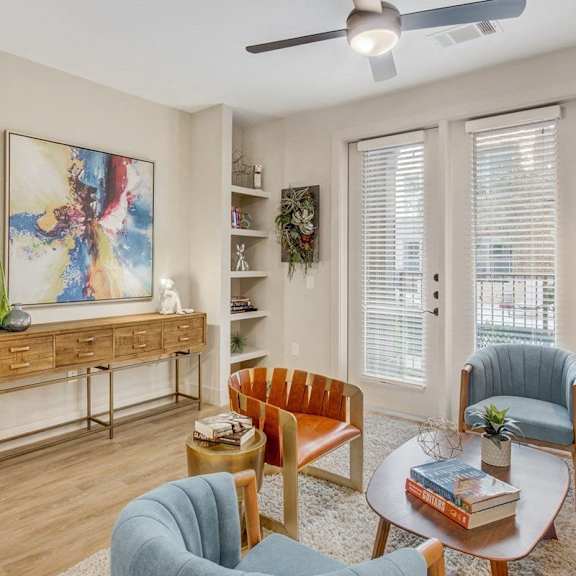 a living room with a blue chair and a coffee table.