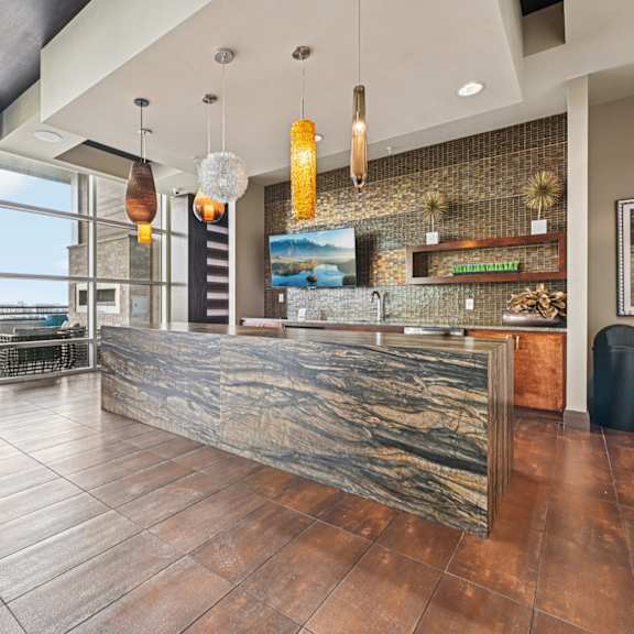 a reception area with a stone counter and a large window.