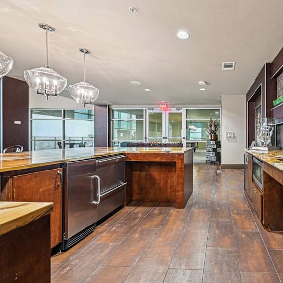 a modern kitchen with wooden floors and stainless steel appliances.