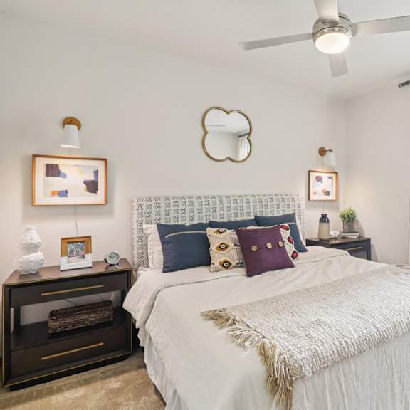 a bedroom with a large bed and a ceiling fan.