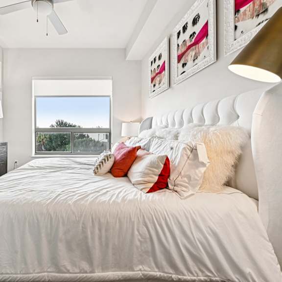 a bedroom with a large bed, a dresser, and a mirror.