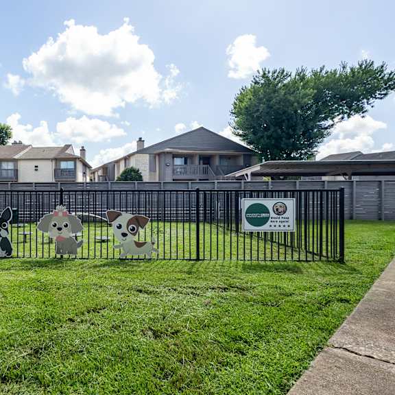 a black fence with cartoon dog decorations on it.