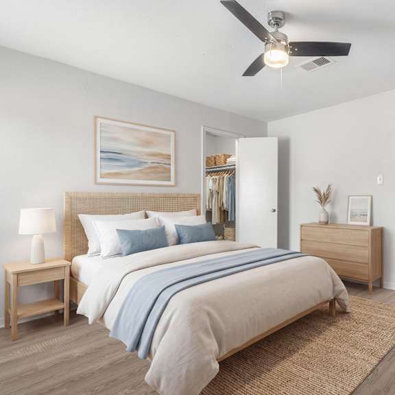 a bedroom with a large bed and a ceiling fan.