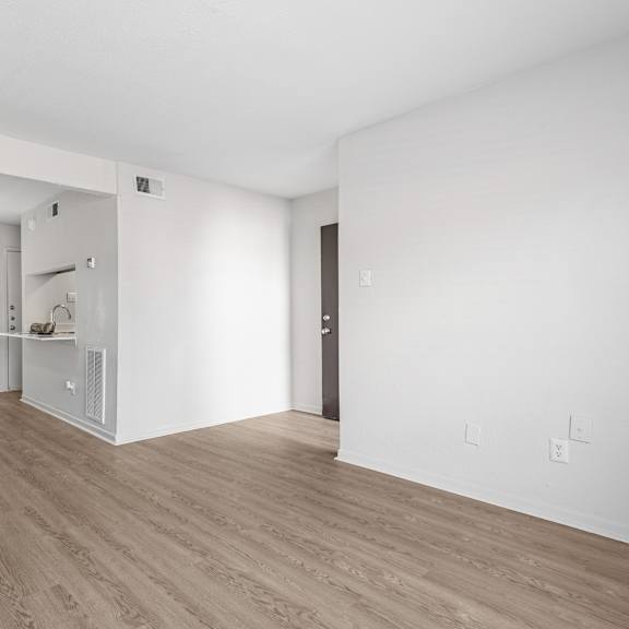 a room with wooden flooring and white walls.