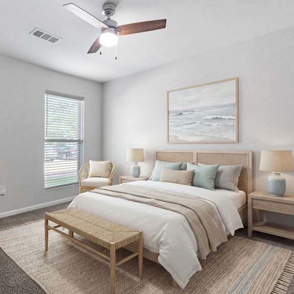 a bedroom with a bed, nightstands, and a ceiling fan.