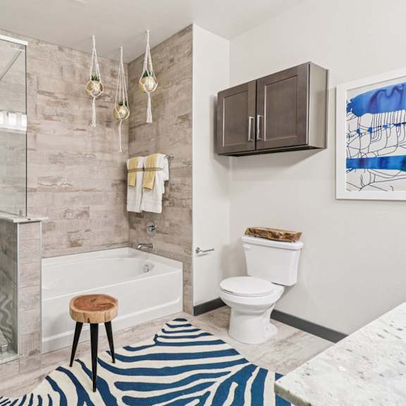 a bathroom with a zebra rug on the floor.