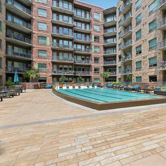 a large outdoor swimming pool surrounded by apartment buildings.