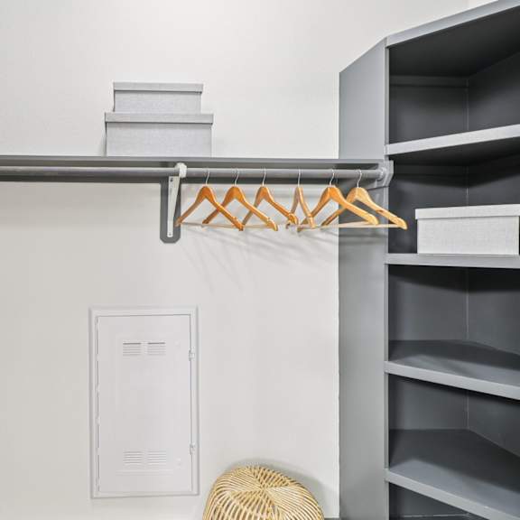 a white closet with a hanger and a white box.