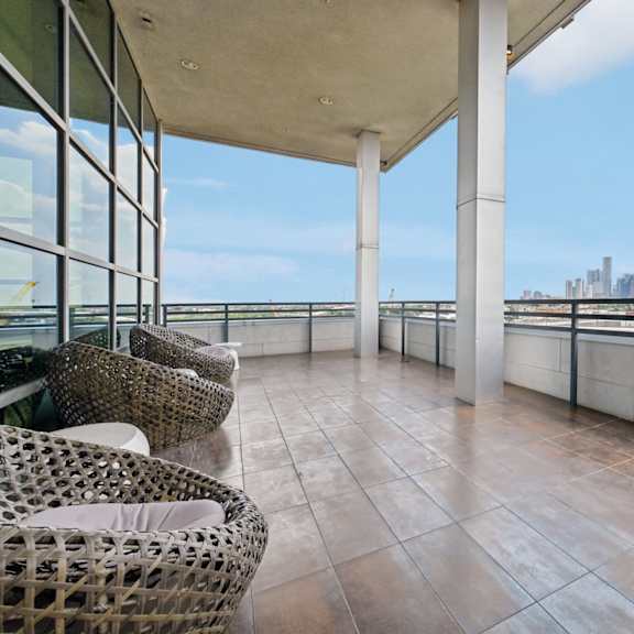rooftop deck with a view of a city skyline.
