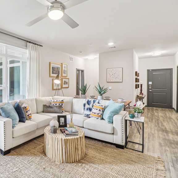 a living room with a white couch and a round table.