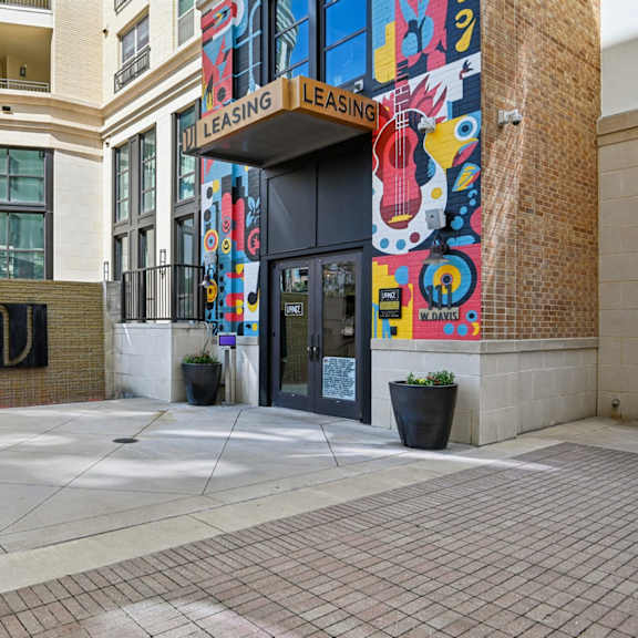 a building with a leasing sign on the side.