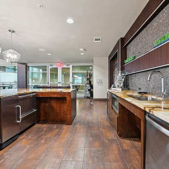 a modern kitchen with wooden floors and stainless steel appliances.