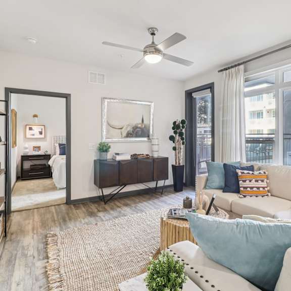 a living room with a white couch and a rug.