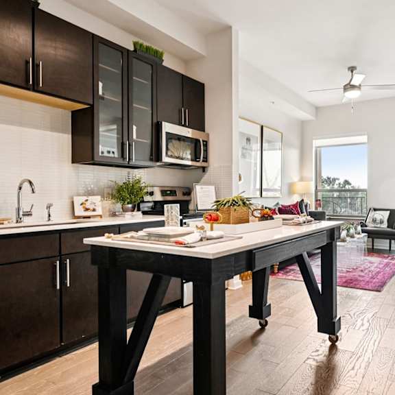 a modern kitchen with a table and chairs in the middle of the room.