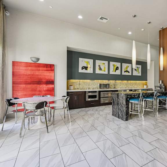 a modern dining room with a red wall and a marble floor.