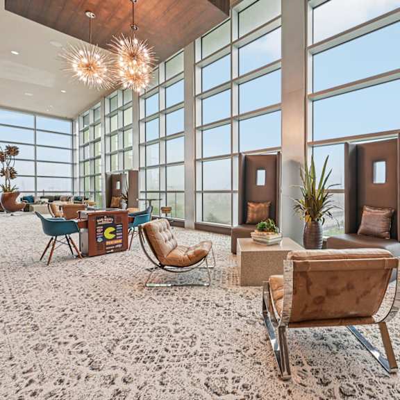 a room with a lot of windows and a carpet on the floor.