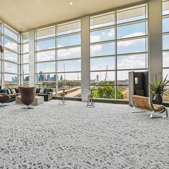 a room with a pool table and a view of the city.