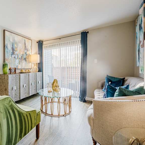 a living room with a green chair and a white couch.