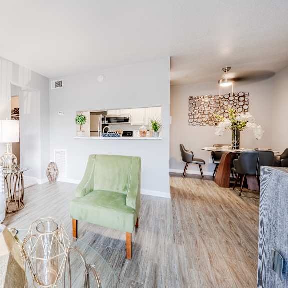 a living room with a white couch and a green chair.