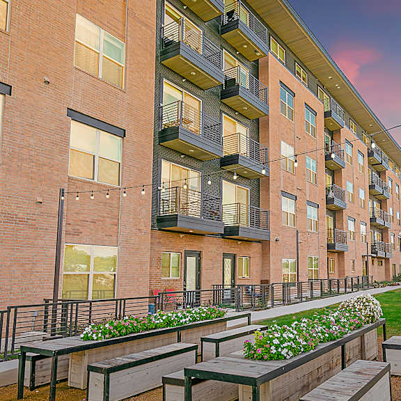 apartment building with balconies and flower boxes.