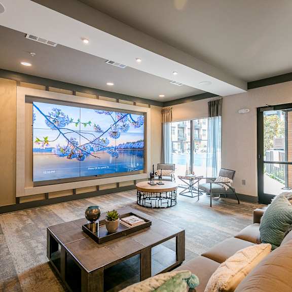 a living room with a large screen and a couch.