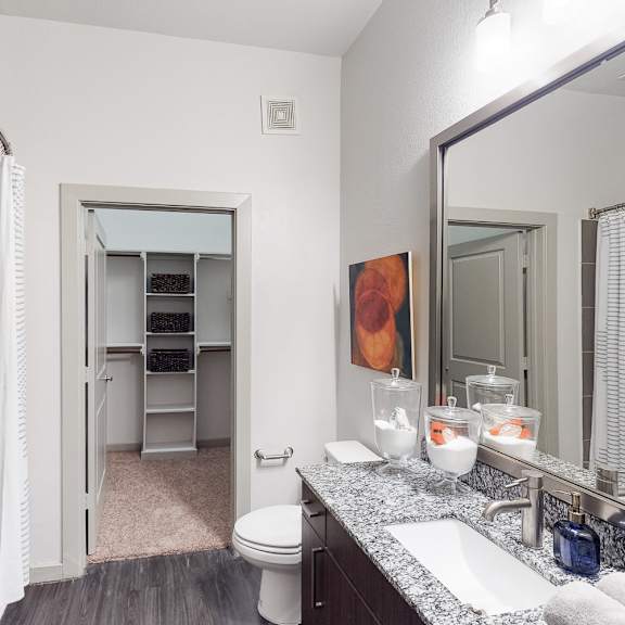 a bathroom with a white towel hanging on the shower rod.