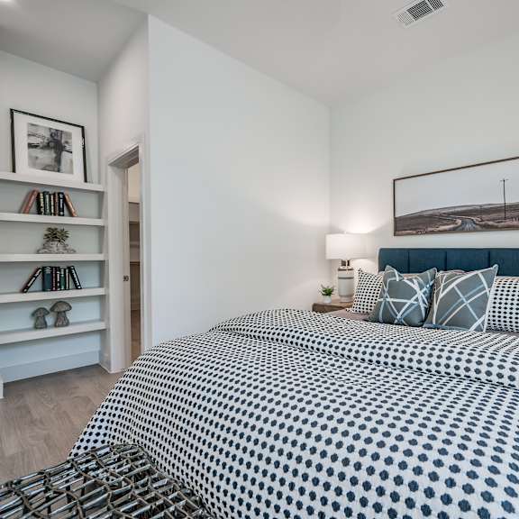 a bedroom with a bed and two night stands with lamps