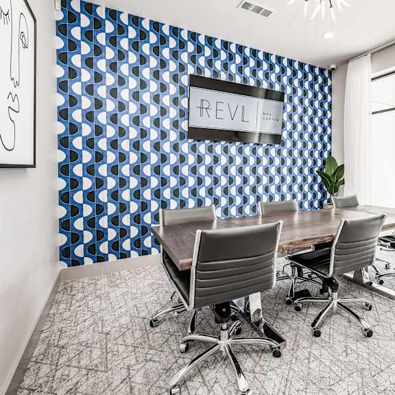 a conference room with a blue and white wall and a table and chairs