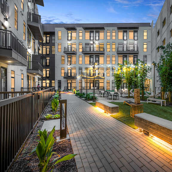 a view of the courtyard at dusk at the m on hennepin apartments in min
