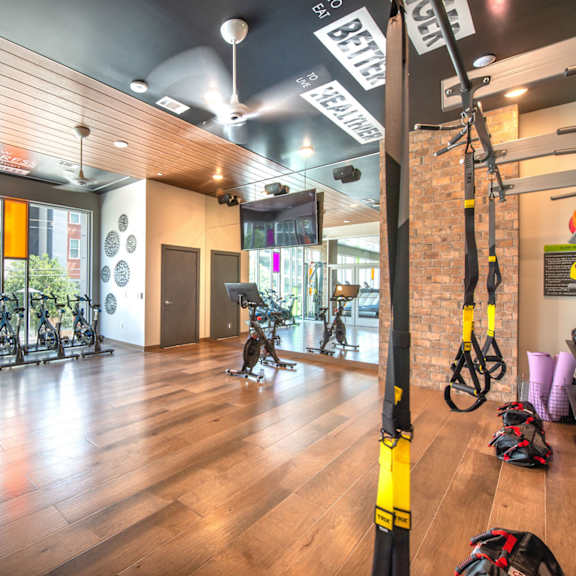 a gym with exercise equipment and a sign that says