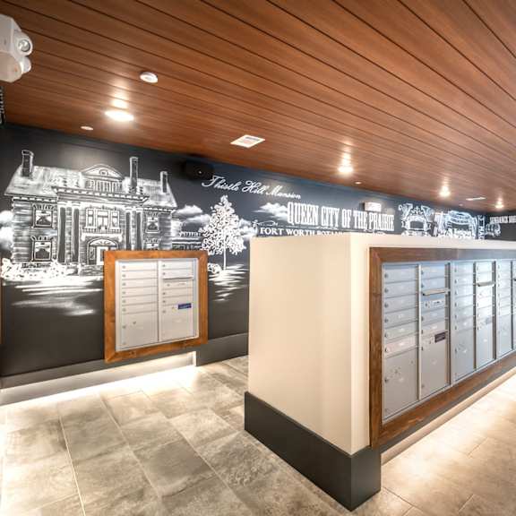a long hallway with a wooden ceiling and a mural on the wall.