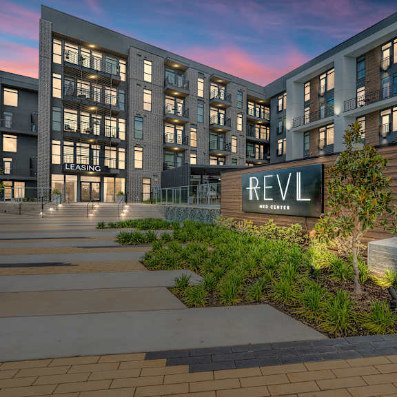 a rendering of a building with a sign that says reval apartments