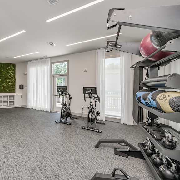 a spacious fitness room with a green accent wall