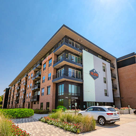 a modern building with a car parked in front of it.