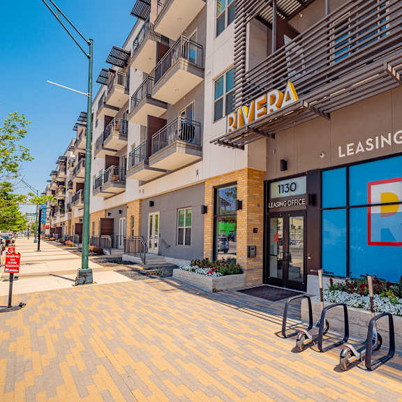 a leasing office for rivera apartments is shown with a blue sign on the window.