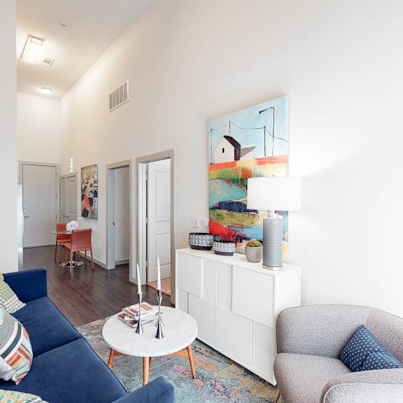 a blue couch with a pillow on it sits in a living room.
