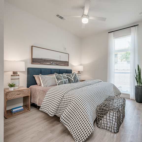 a bedroom with a bed and a ceiling fan