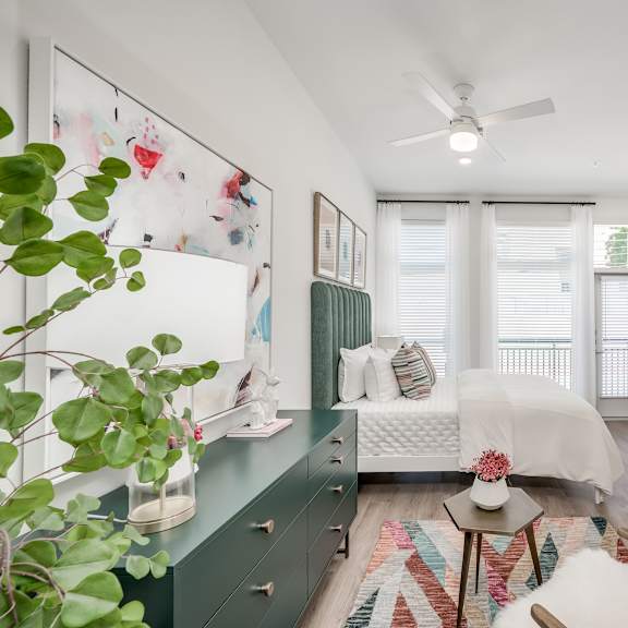 a bedroom with a bed and a ceiling fan