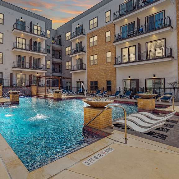 a swimming pool surrounded by apartment buildings.