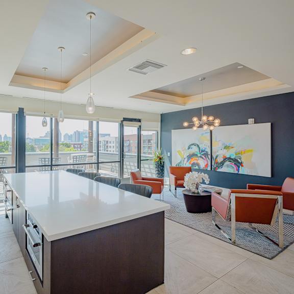 a modern kitchen with a large island and a view of the city.