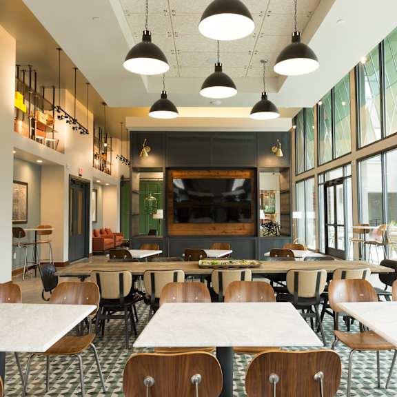 a modern dining area with tables and chairs.