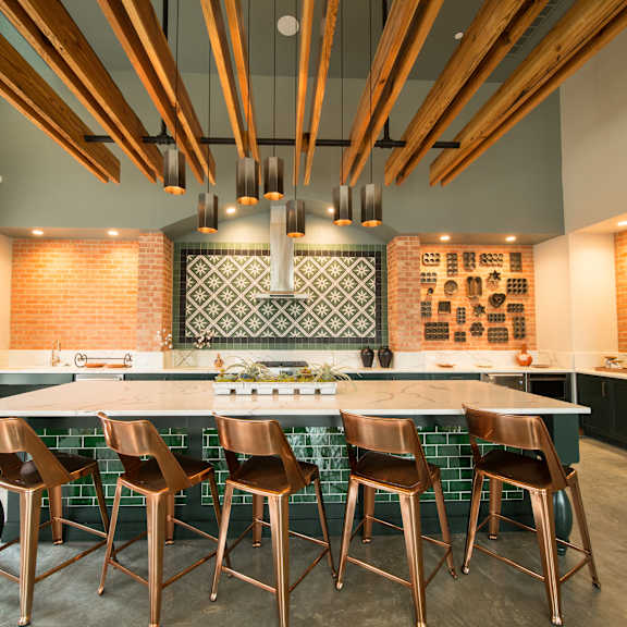 a kitchen with a long table and chairs.