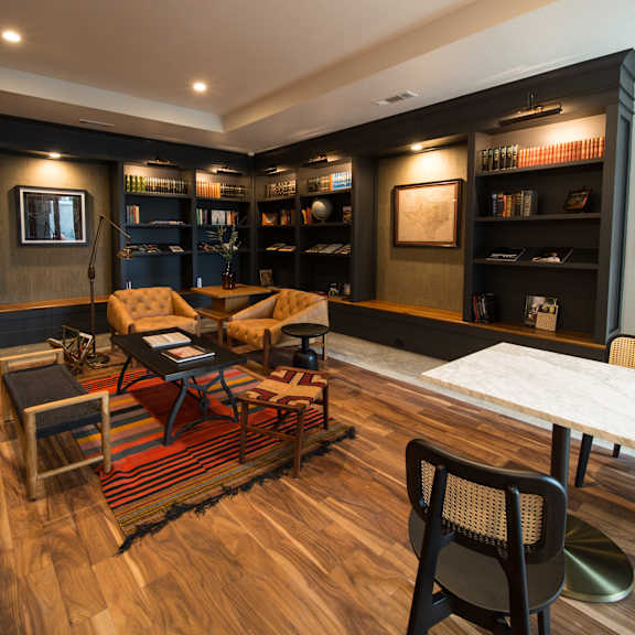 a living room with a wooden floor and a white table.