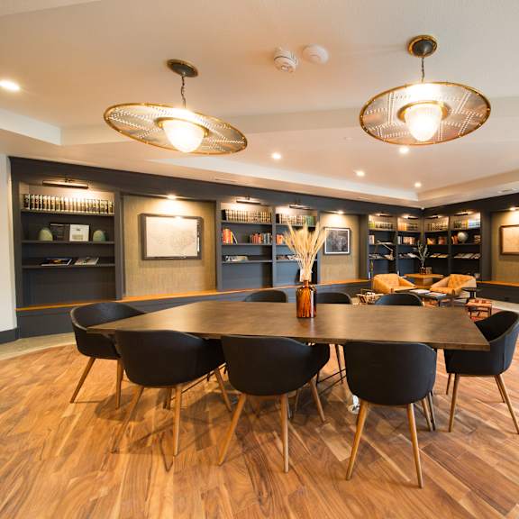 a modern dining room with a large table and chairs.