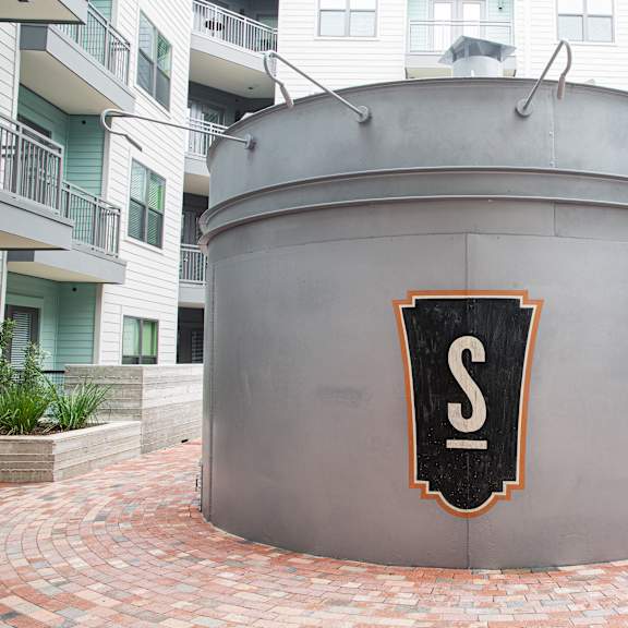 a large grey structure with a black and white logo in the center.