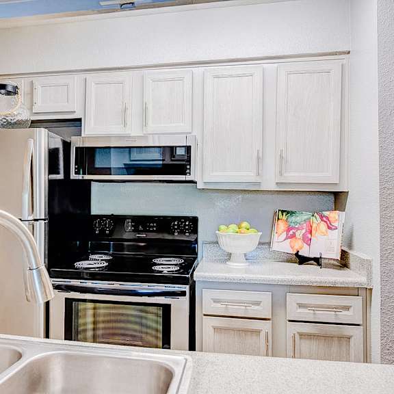 a kitchen with a stove, oven, and sink.