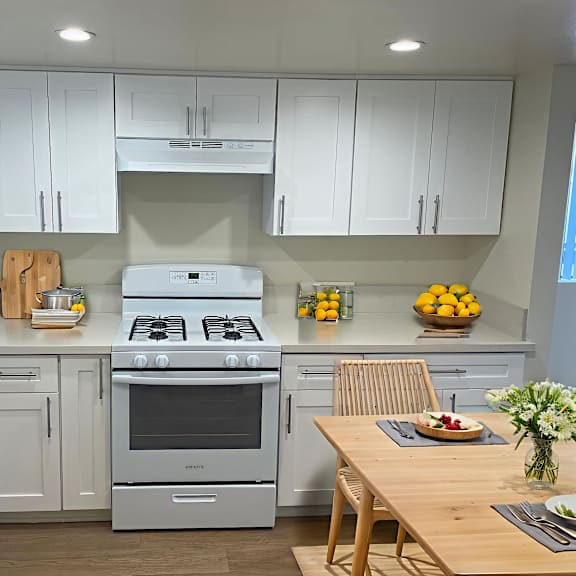 a modern kitchen with a stove, oven, and cabinets.