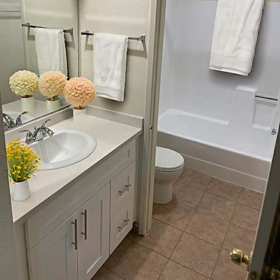 a bathroom with a white sink and a white toilet.