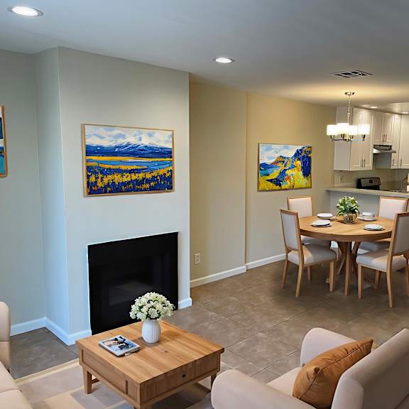 a living room with a fireplace and a painting on the wall.
